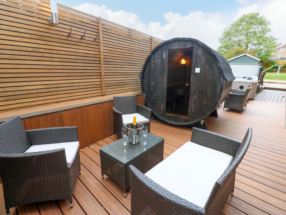 An outdoor space with a sauna and seating area at The Miners Hall Retreat, Stanley, County Durham