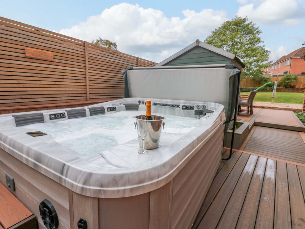 A hot tub with an ice bucket in an outdoor area at The Miners Hall Retreat in Stanley, County Durham
