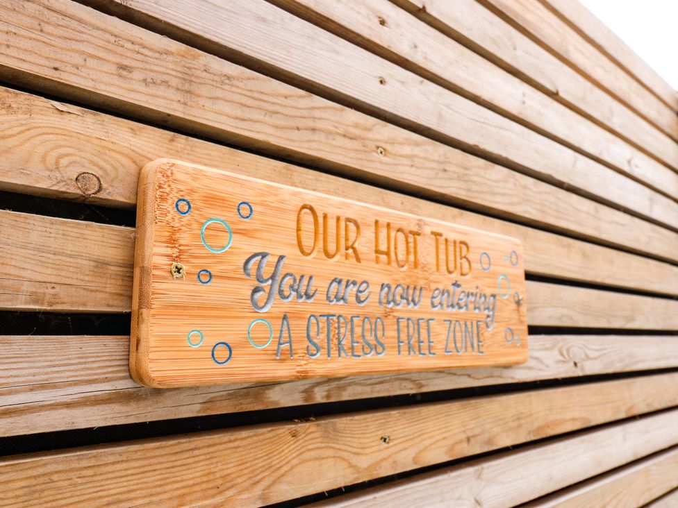 A sign indicating a hot tub area at The Miners Hall Retreat in Stanley, County Durham