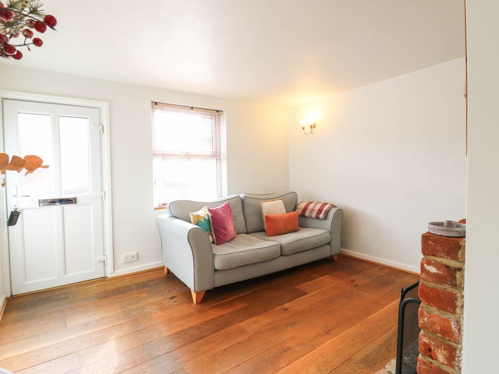 A living room with a sofa and a door at 5 Prospect Place in Woodbridge