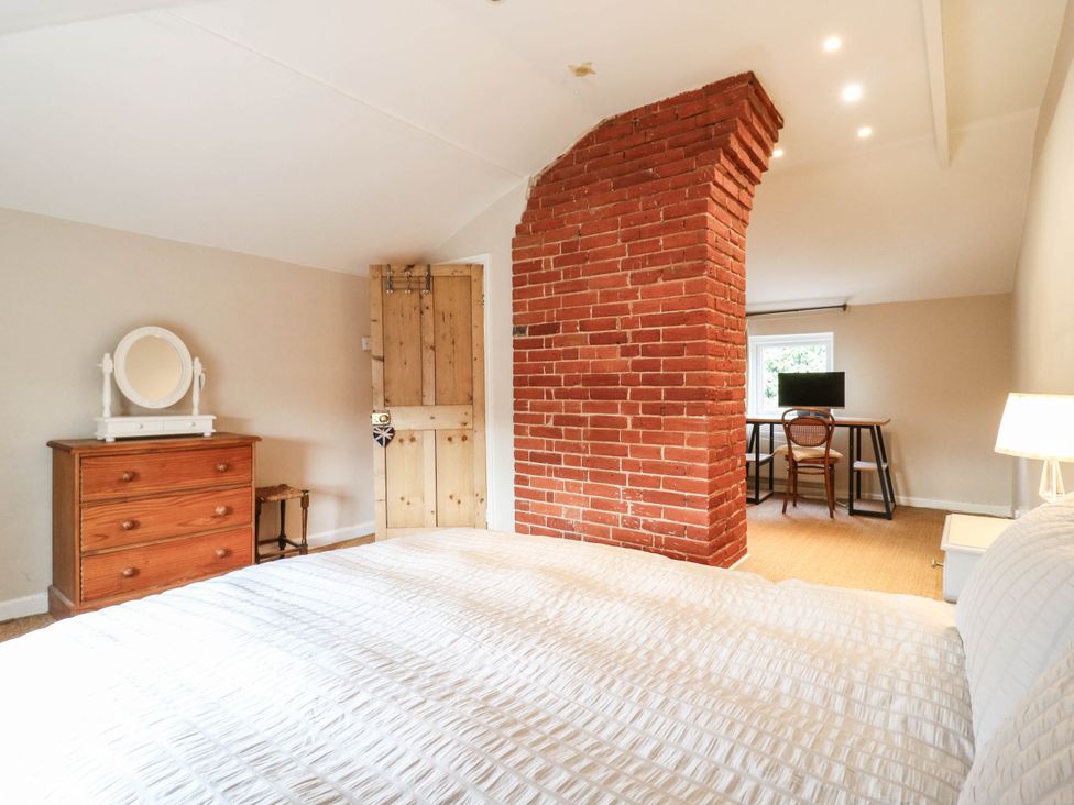 A bedroom with a bed, dresser, desk and chair at 5 Prospect Place in Woodbridge