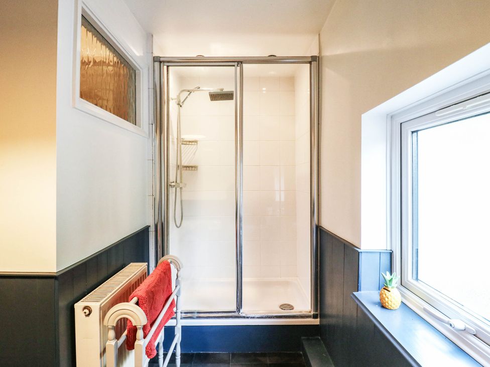 A bathroom with a shower and a window at 5 Prospect Place in Woodbridge