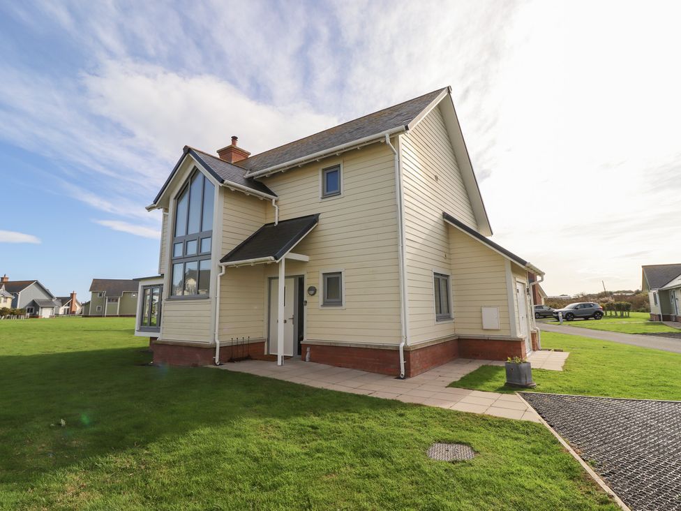 An exterior view of a house with a garden at The Beach House in Beadnell