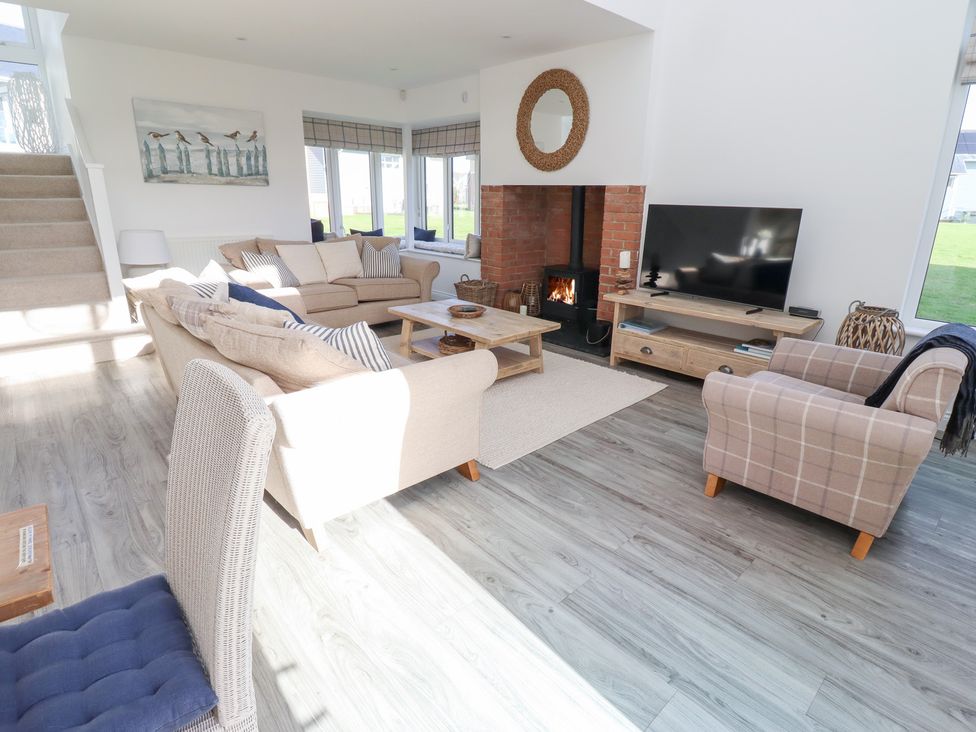 A living room with a sofa and television at The Beach House (Beadnell)