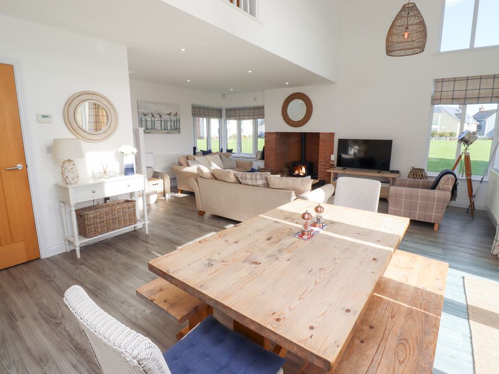 A living room with a table and chairs at The Beach House (Beadnell)