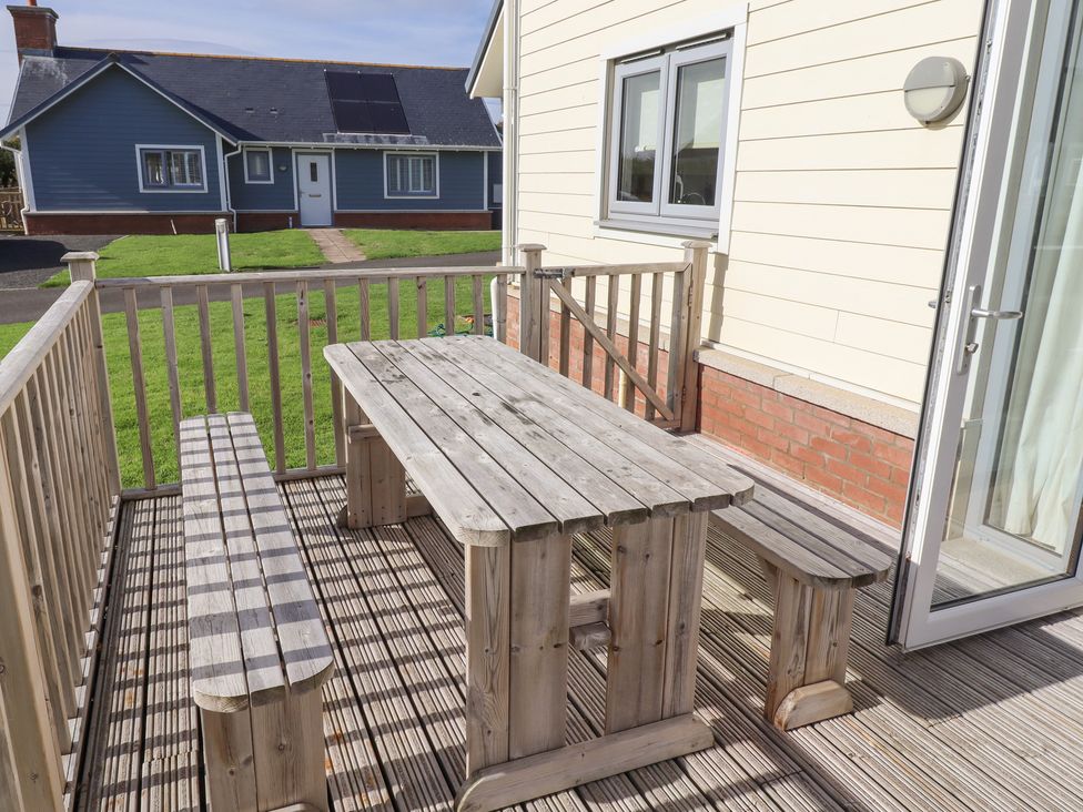 A wooden table and benches on an outdoor patio at The Beach House (Beadnell) Beadnell