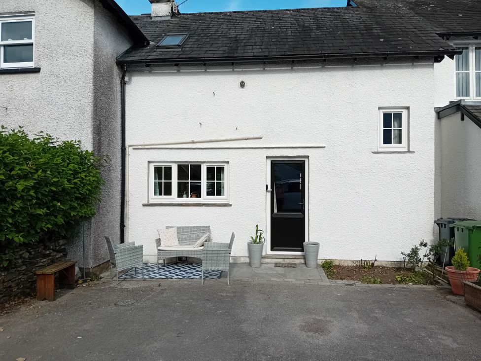A house exterior with seating and plants at Swallows Nest Cottage in Hawkshead