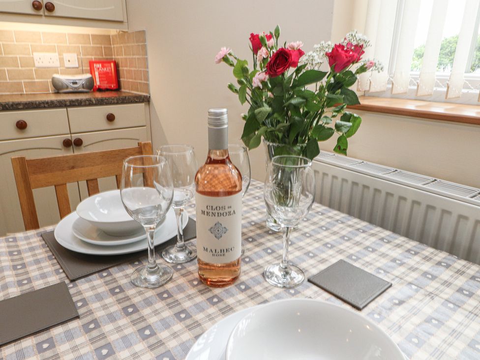 A dining room with a table set for dinner at Bryn Caled in Llanarmon near Y Ffor
