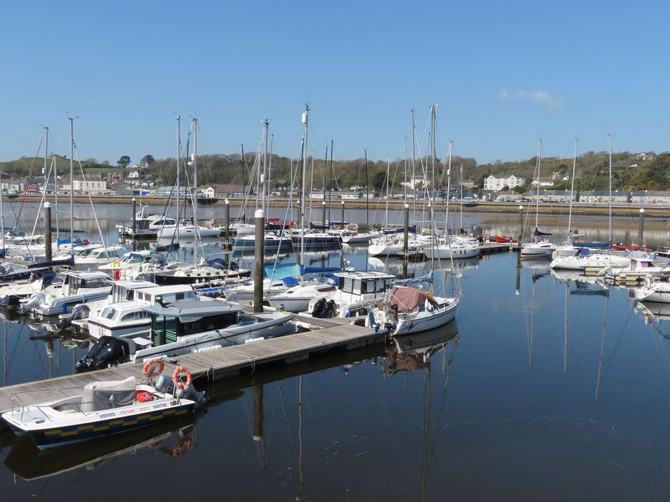 A marina with boats docked and water reflecting at Bryn Caled Llanarmon near Y Ffor