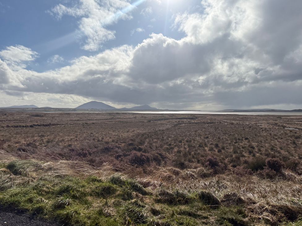 A view of hills and water under a cloudy sky at Geesala