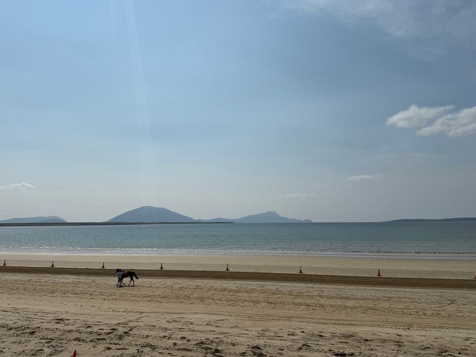 A beach with a horse in the distance at Geesala