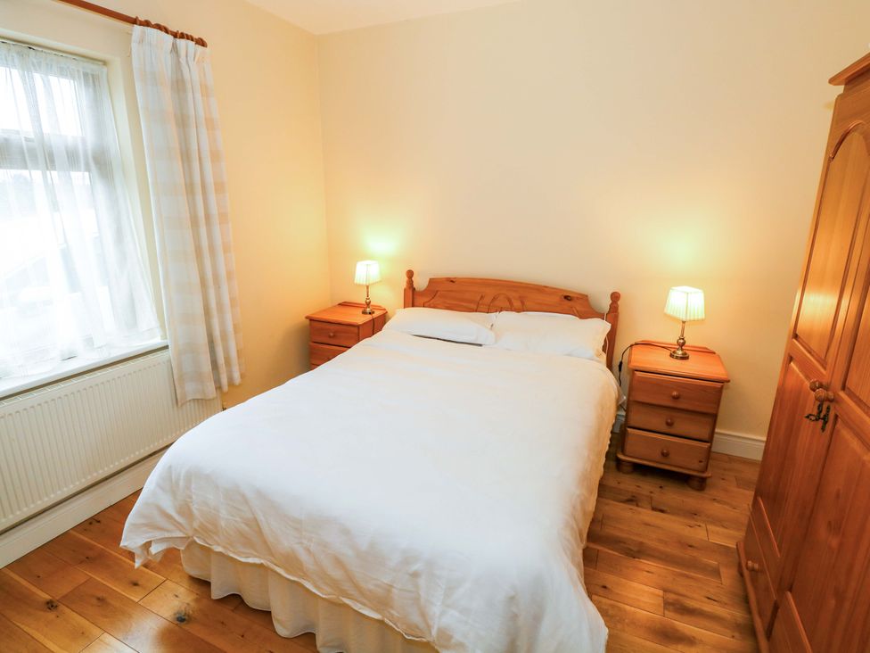 A bedroom with a bed and nightstands at Geesala in Gweesalia