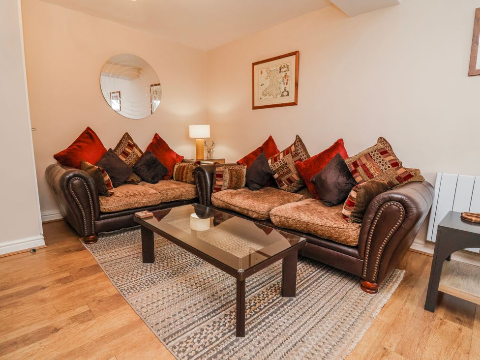 A living room with a sofa and coffee table at Acorns in Holywell