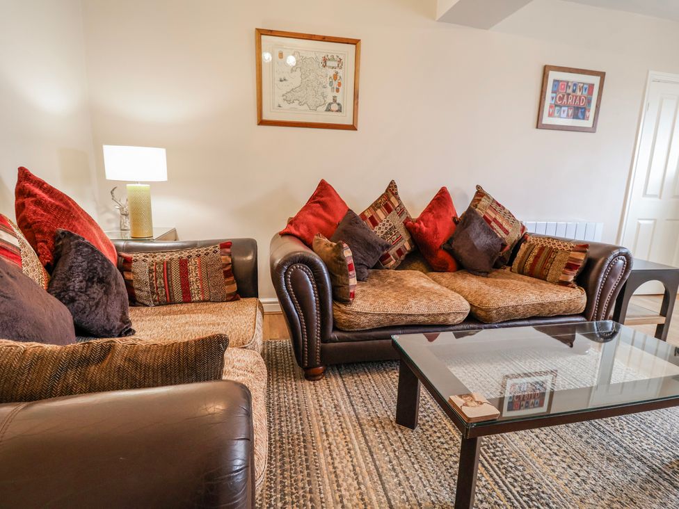 A living room with a sofa and coffee table at Acorns in Holywell