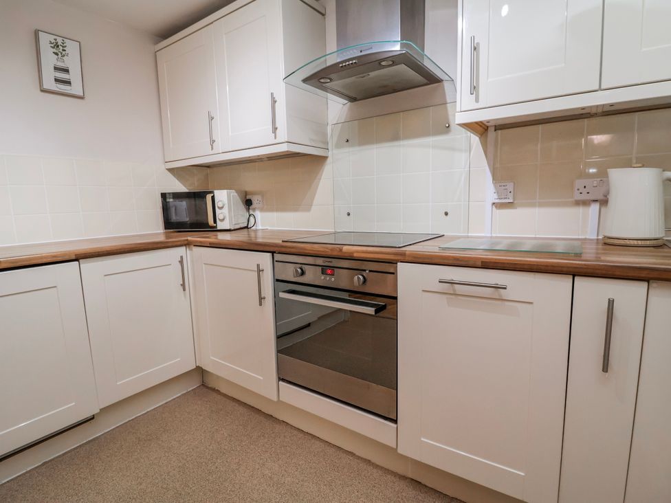 A kitchen with microwave and oven at Acorns in Holywell