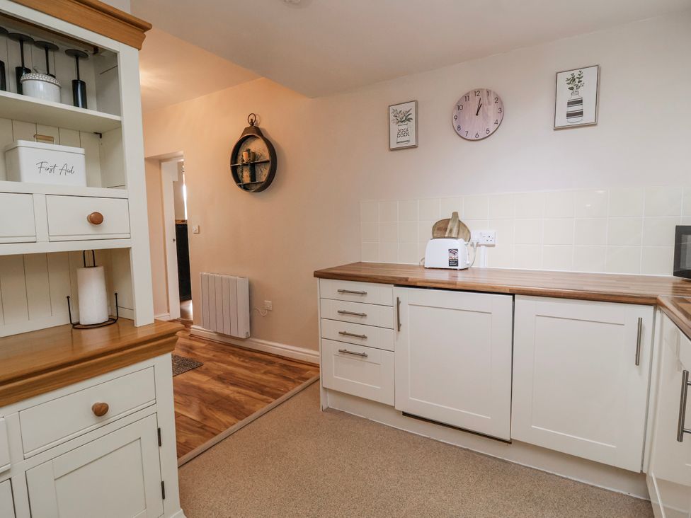 A kitchen with cabinets and a toaster at Acorns in Holywell