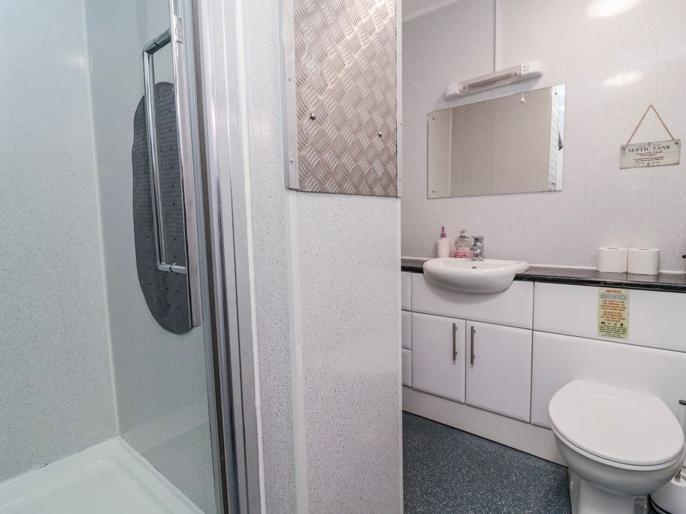 A bathroom with a shower and sink at Acorns in Holywell