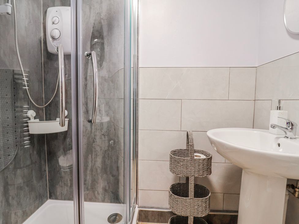 A bathroom with a shower and sink at Acorns in Holywell