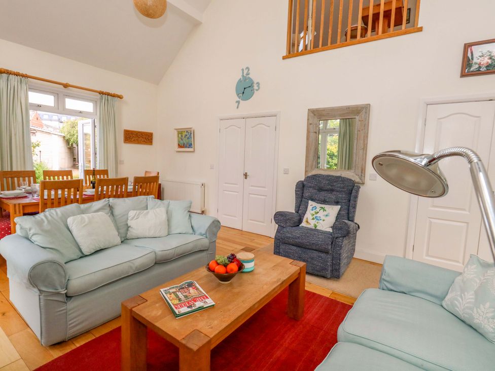 A living room with a sofa and coffee table at 1 Fernhill Avenue Weymouth