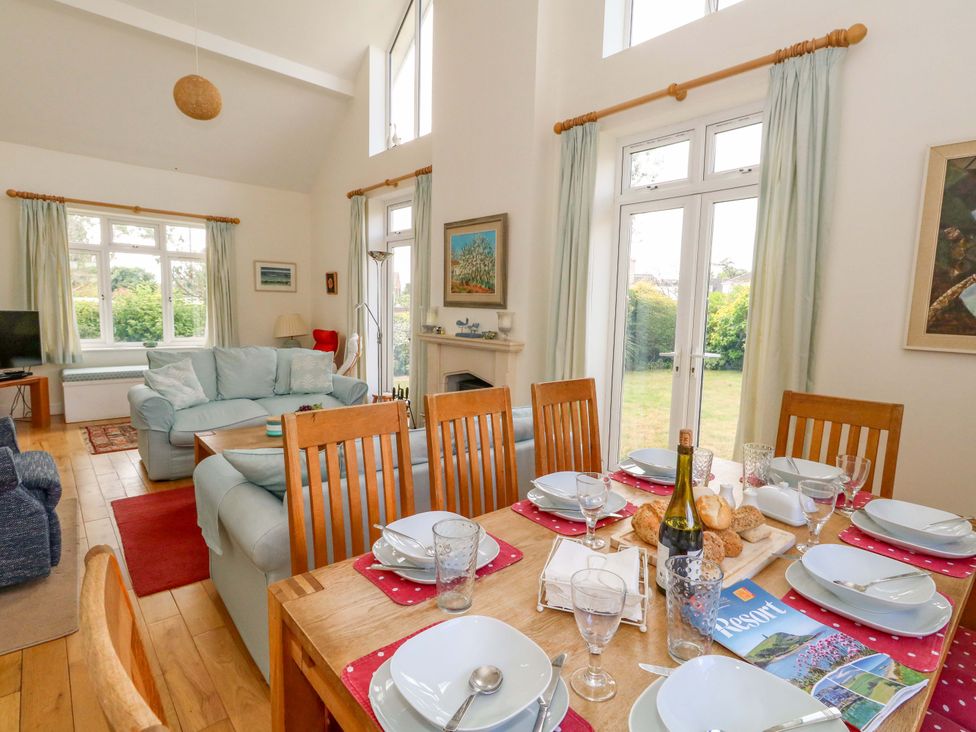 A dining room with a table set for a meal at 1 Fernhill Avenue Weymouth