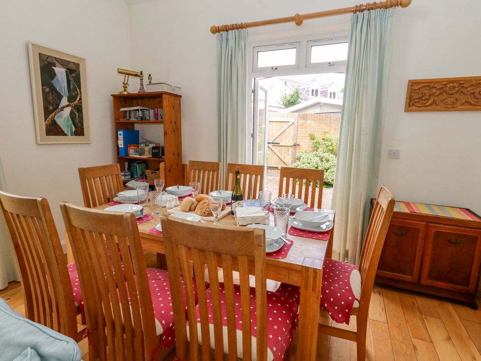 A dining room with a table set for a meal at 1 Fernhill Avenue Weymouth