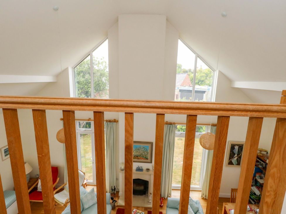 A living room with a balcony view at 1 Fernhill Avenue in Weymouth