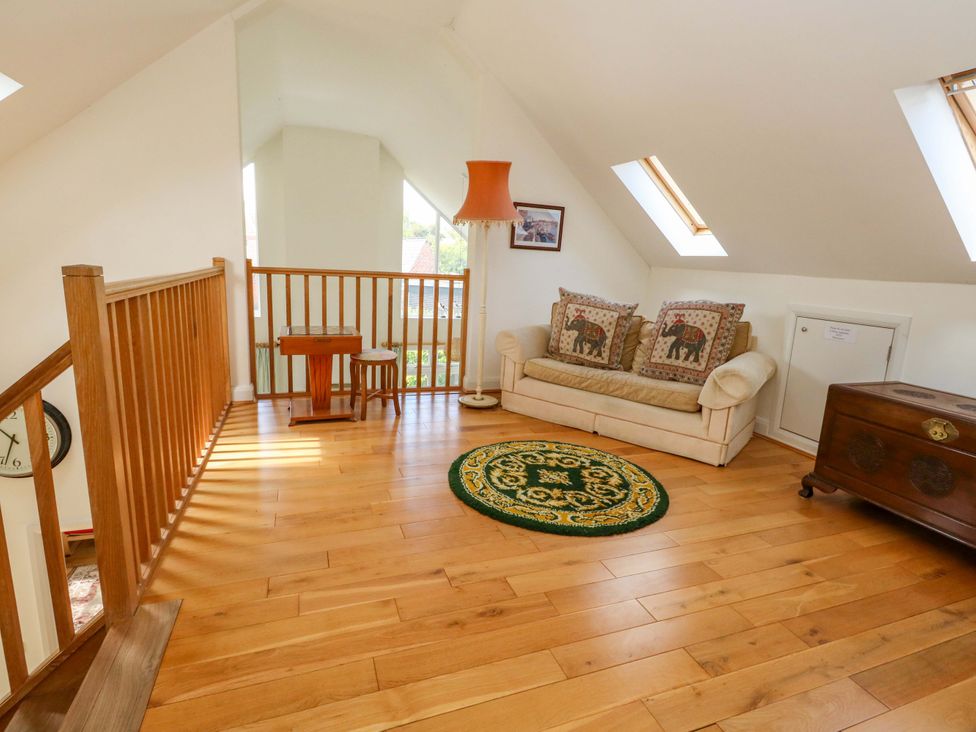 A loft with a sofa and table at 1 Fernhill Avenue Weymouth