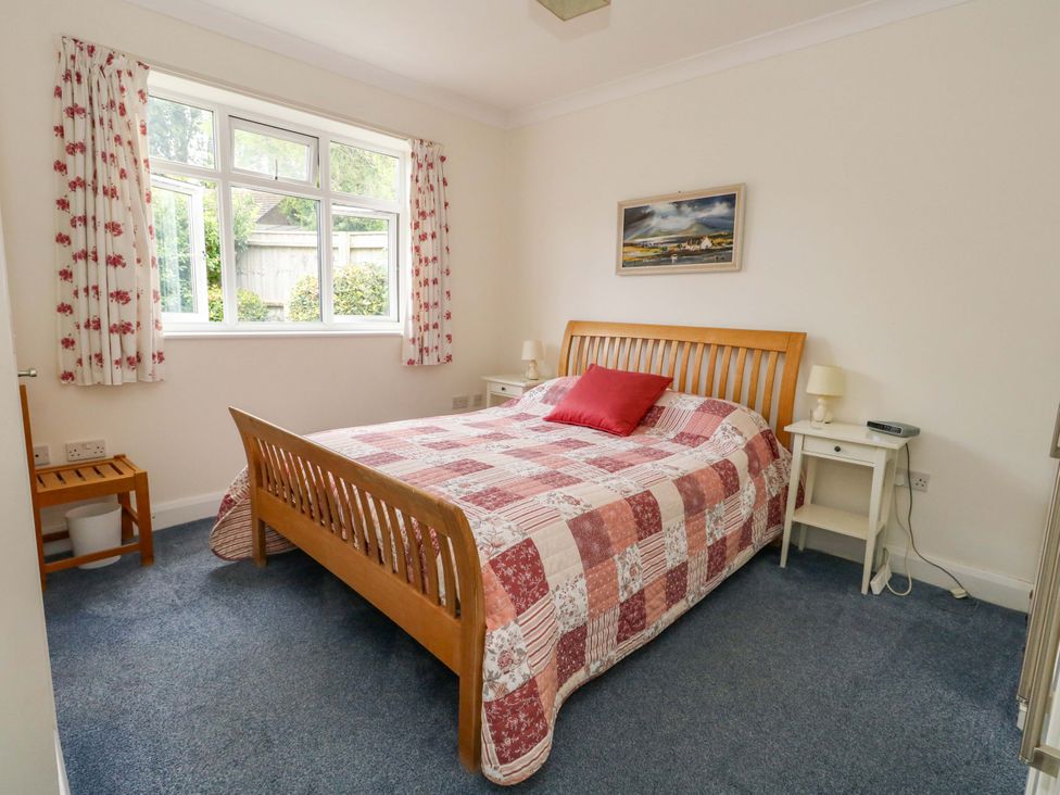 A bedroom with a bed and window at 1 Fernhill Avenue Weymouth