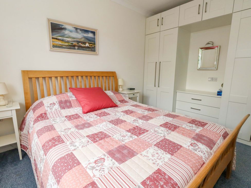A bedroom with a bed and a wardrobe at 1 Fernhill Avenue Weymouth