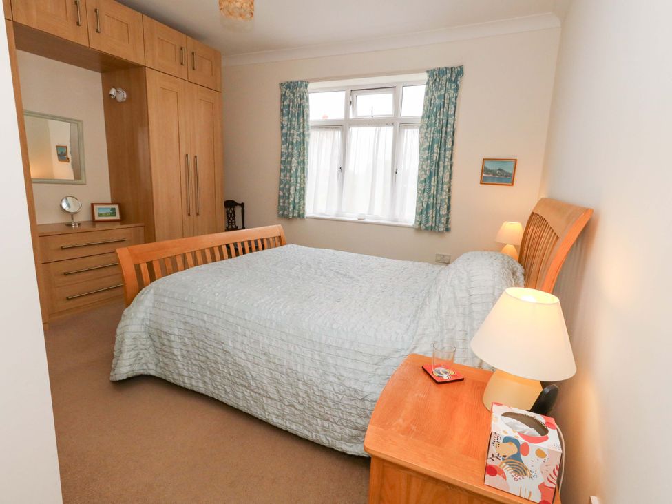 A bedroom with a bed and wardrobe at 1 Fernhill Avenue in Weymouth