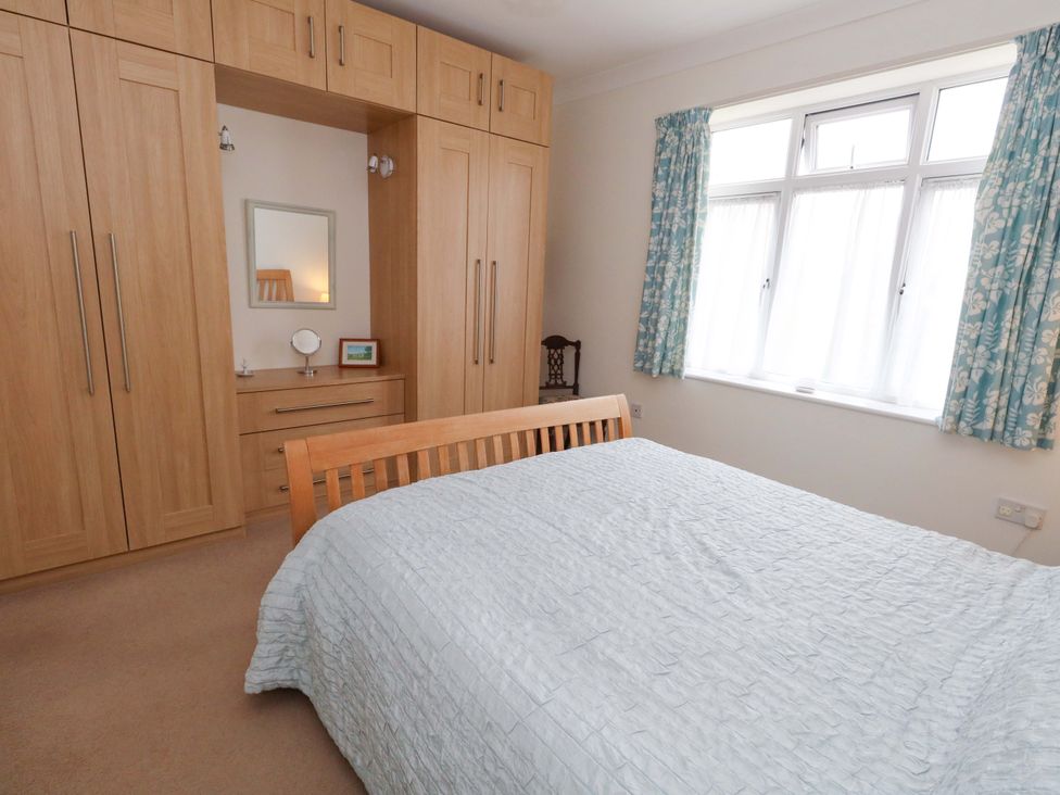 A bedroom with a bed and wardrobe at 1 Fernhill Avenue Weymouth