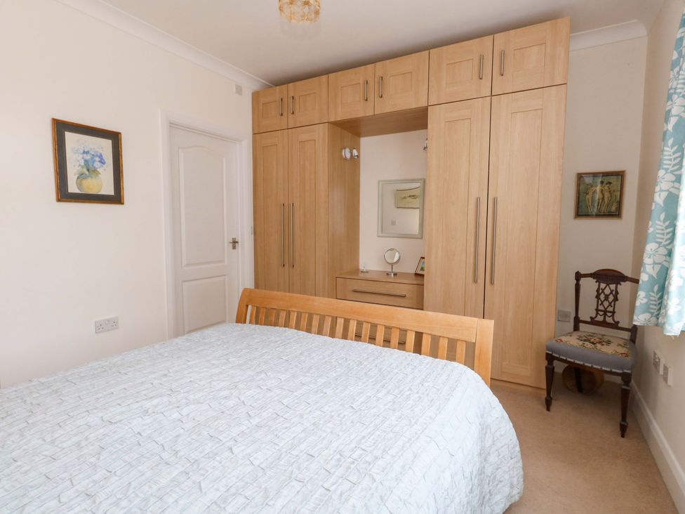 A bedroom with a bed and wardrobe at 1 Fernhill Avenue Weymouth