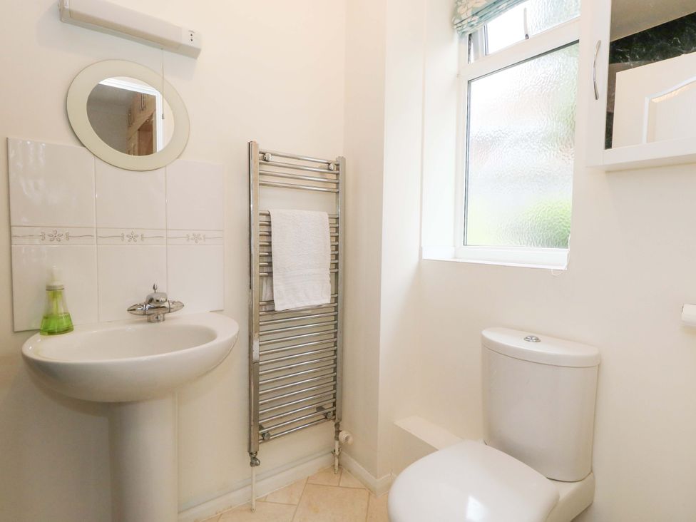 A bathroom with a sink and toilet at 1 Fernhill Avenue Weymouth