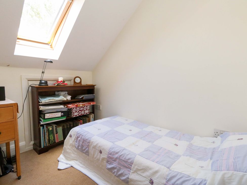 A bedroom with a bed and desk at 1 Fernhill Avenue Weymouth