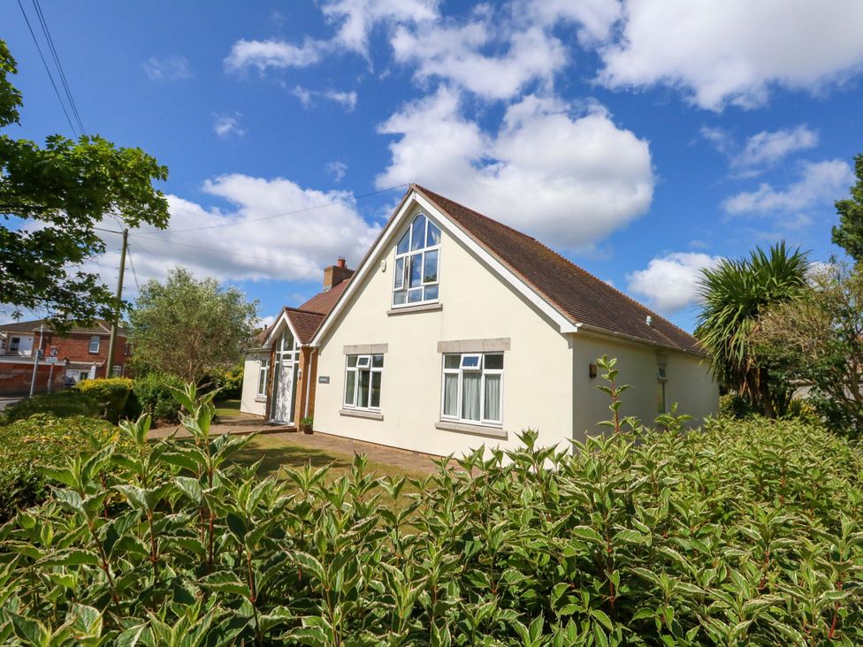 A house with windows and bushes at 1 Fernhill Avenue Weymouth