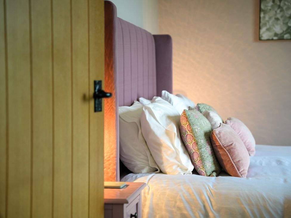 A bedroom with a bed and pillows at Dol Blodau in Newbridge-On-Wye