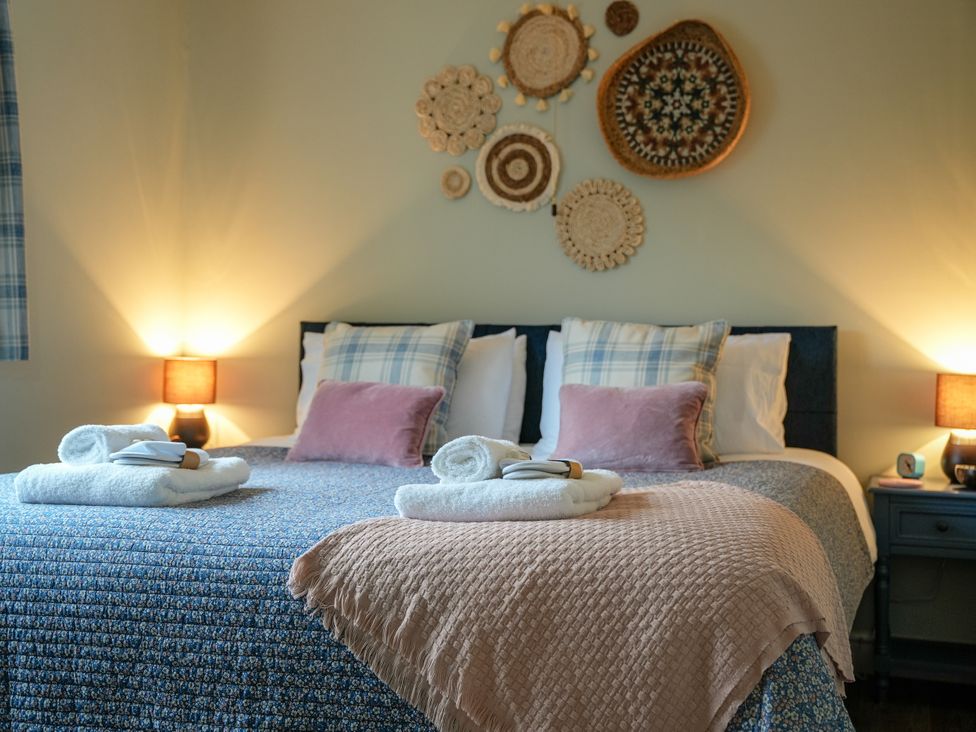 A bedroom with a bed and decorative wall art at Ystrad Wen in Llysdinam near Newbridge-On-Wye