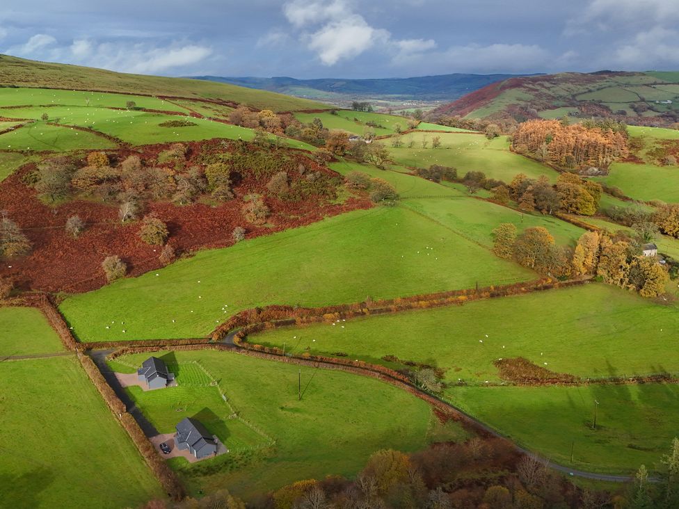 An aerial view of fields and houses at Ystrad Wen in Llysdinam near Newbridge-On-Wye