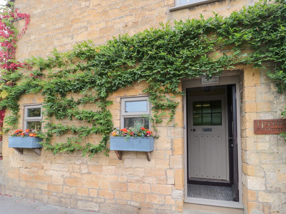 An entryway with flower boxes and ivy at Yarn Cottage Broadway