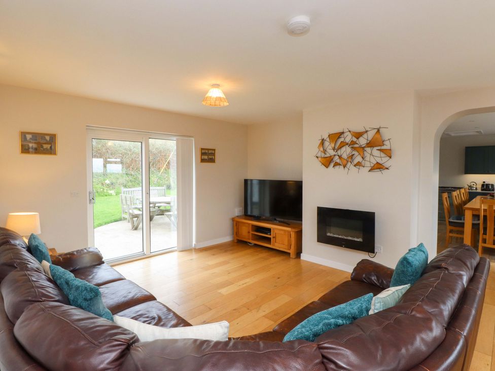 A living room with a sofa and television at Belan Wen Llanddona near Pentraeth