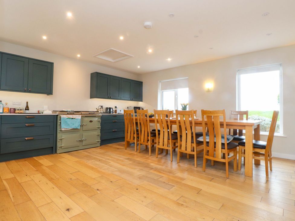 A kitchen with dining table and chairs at Belan Wen Llanddona near Pentraeth