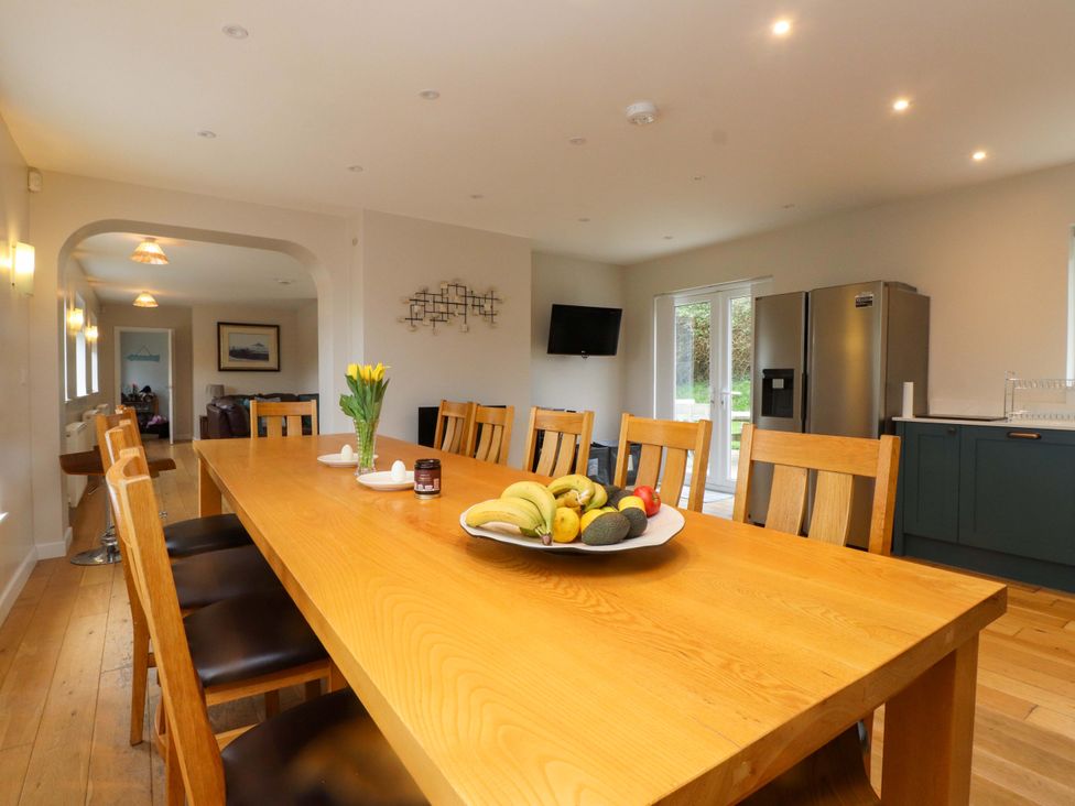 A kitchen with a large wooden table and fruit on it at Belan Wen, Llanddona near Pentraeth