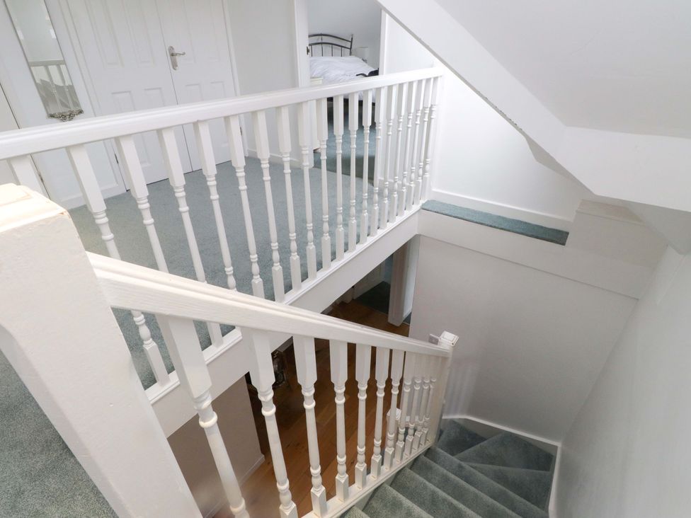 A staircase and railing in a hallway at Belan Wen in Llanddona near Pentraeth