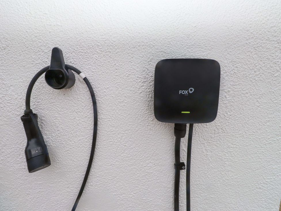 A charging station with cables mounted on a wall at Belan Wen in Llanddona near Pentraeth