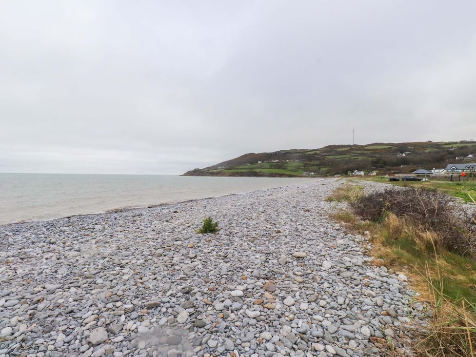 A beach with pebbles and sea at Belan Wen in Llanddona near Pentraeth