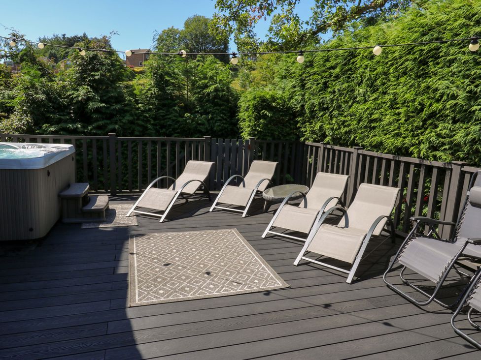 An outdoor area with lounge chairs and a hot tub at The Old Post Office - Pet Friendly Group Stays in Holmfirth