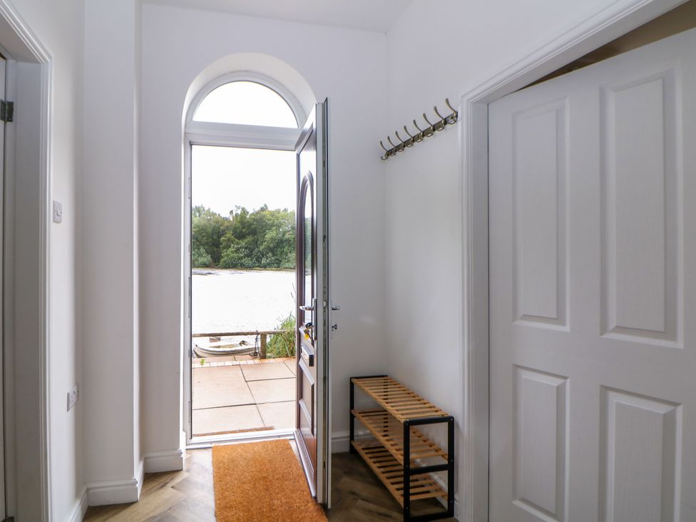 An entrance with a front door and shoe rack at Hardwick in Darley Moor near Two Dales