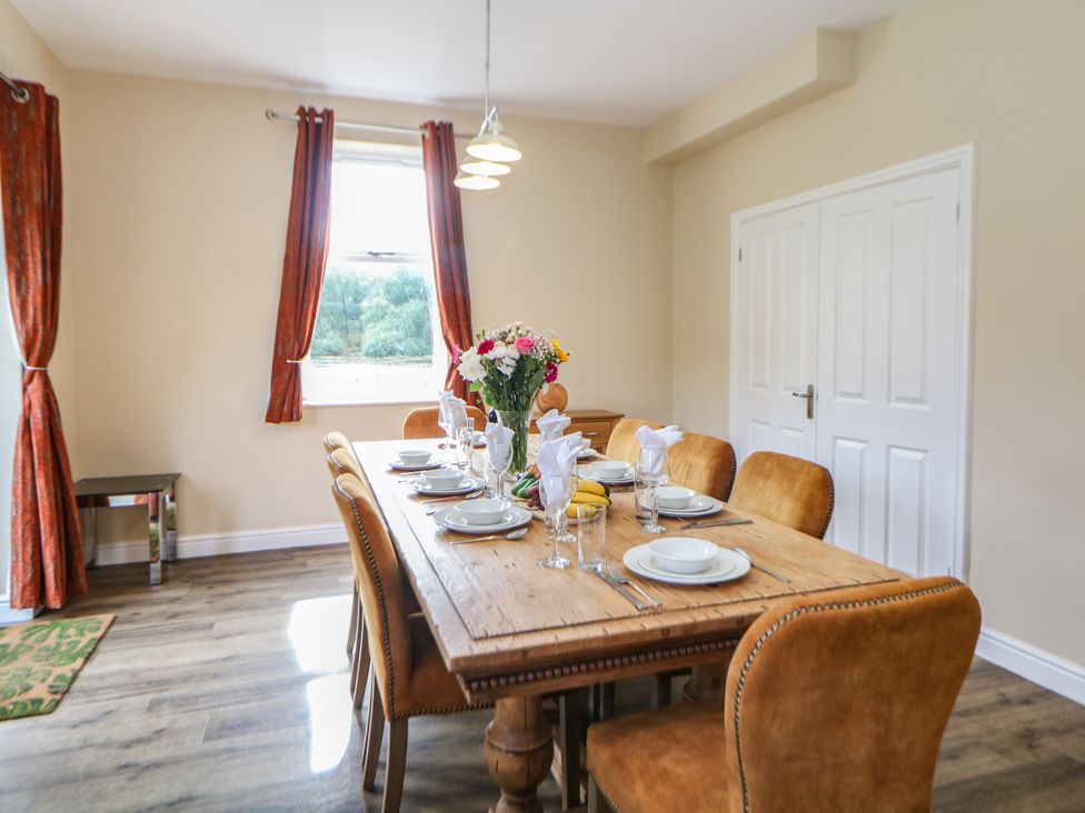 A dining room with a table set for meals at Hardwick in Darley Moor near Two Dales
