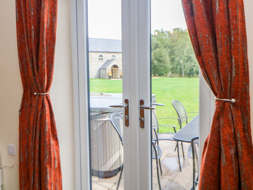 A view of a garden with a hot tub and seating area at Hardwick in Darley Moor near Two Dales