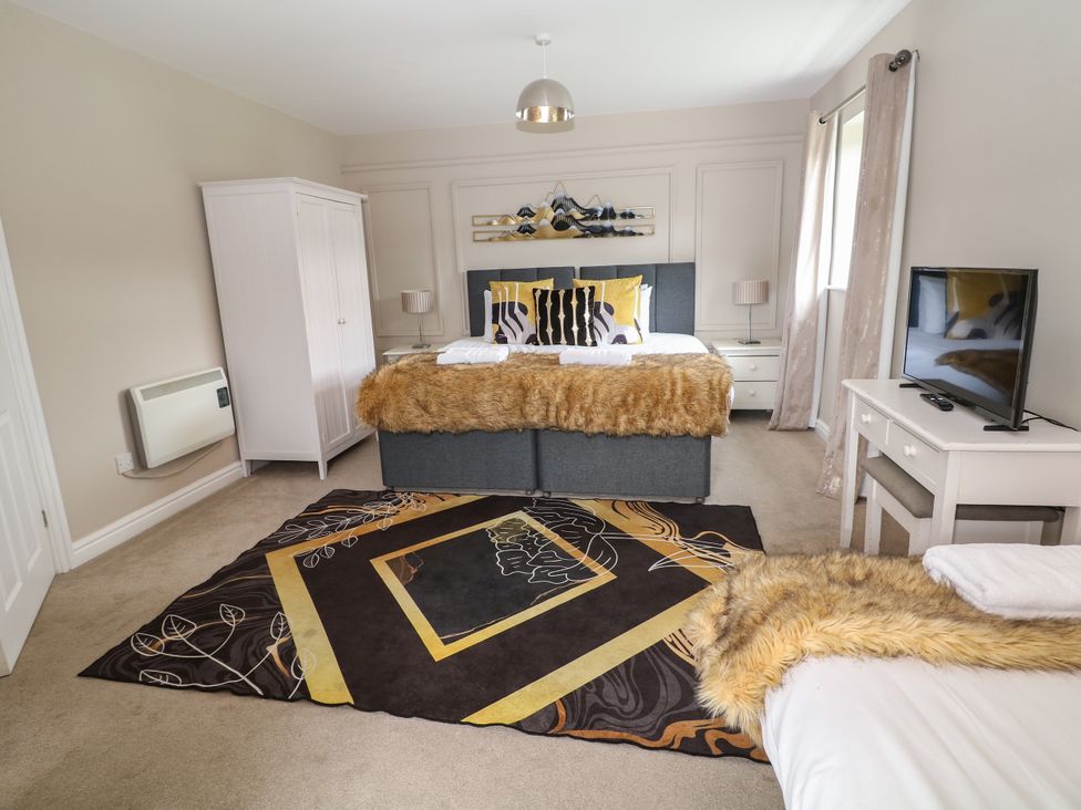 A bedroom with a double bed and a television at Hardwick, Darley Moor near Two Dales